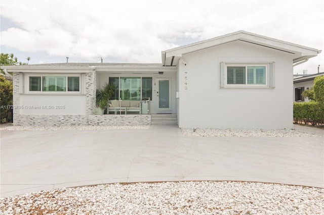 ranch-style house featuring covered porch and a patio