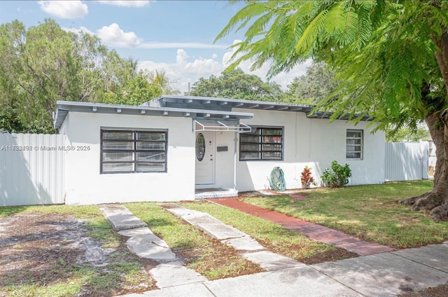 view of front of home with a front lawn