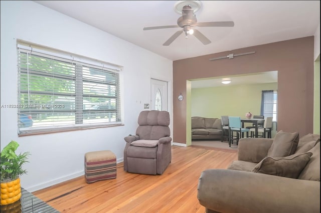 living room featuring hardwood / wood-style floors and ceiling fan