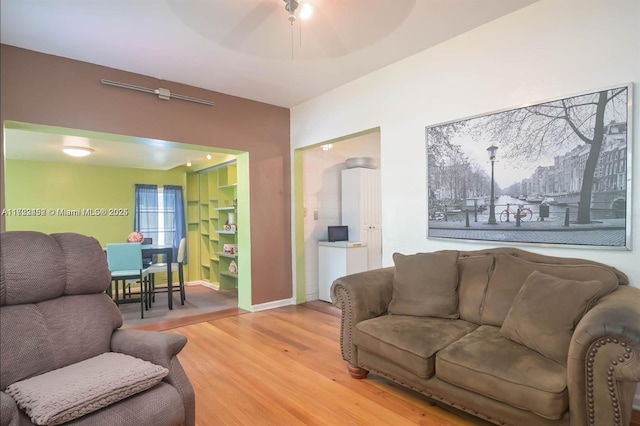 living room with ceiling fan and hardwood / wood-style flooring