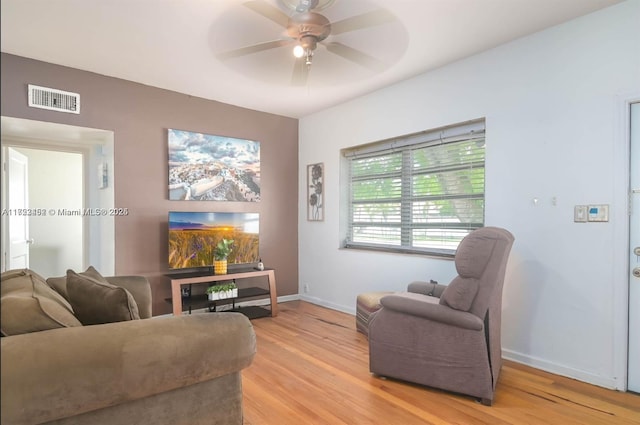 living area featuring light hardwood / wood-style floors and ceiling fan