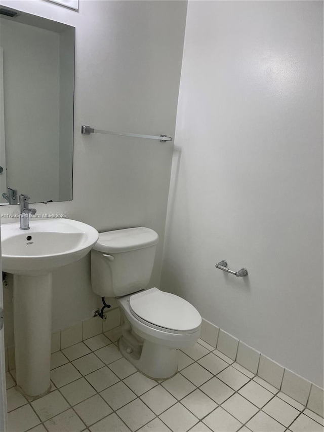 bathroom with tile patterned floors and toilet