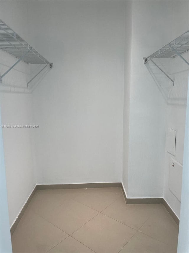 walk in closet with tile patterned floors