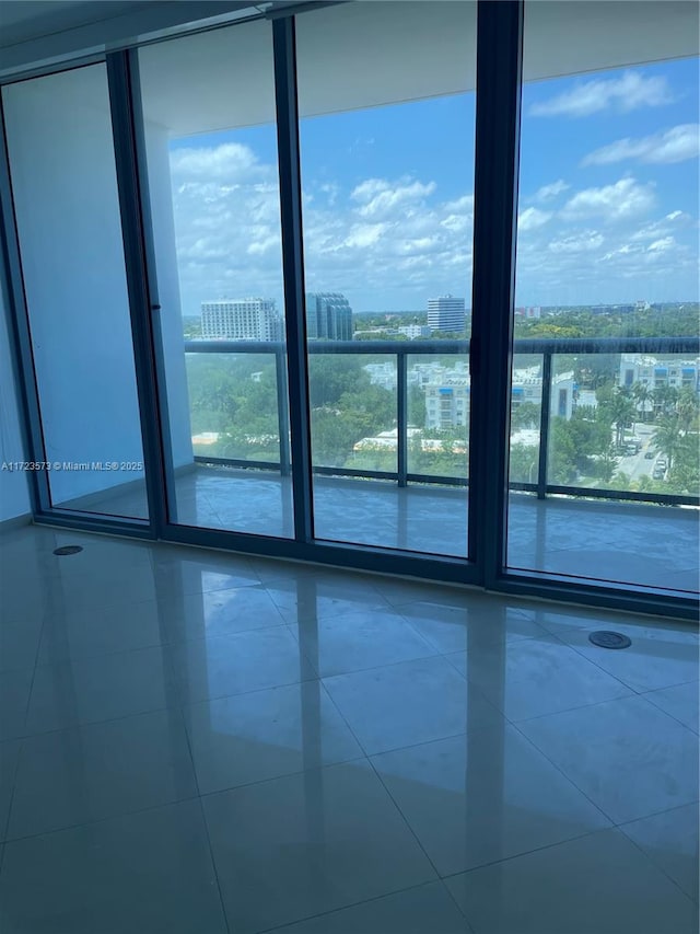 tiled empty room with floor to ceiling windows