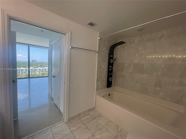 bathroom with floor to ceiling windows and tiled shower / bath combo