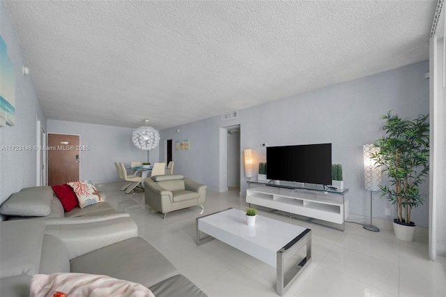 tiled living room featuring a textured ceiling