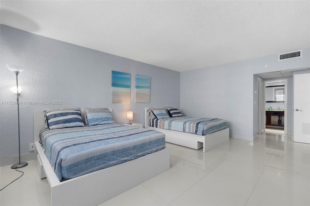 tiled bedroom featuring a textured ceiling