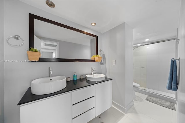 bathroom with tile patterned flooring, vanity, toilet, and an enclosed shower