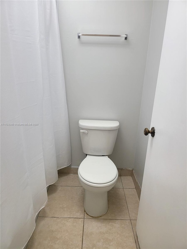 bathroom with tile patterned flooring and toilet