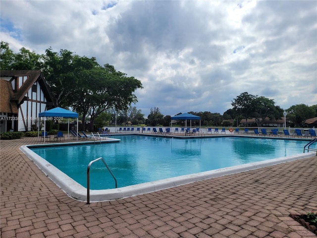 view of swimming pool featuring a gazebo and a patio area