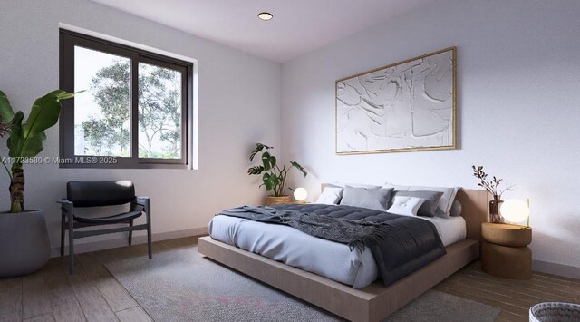 bedroom with hardwood / wood-style floors and multiple windows