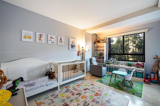 bedroom featuring a crib