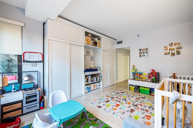 bedroom featuring a crib and a closet