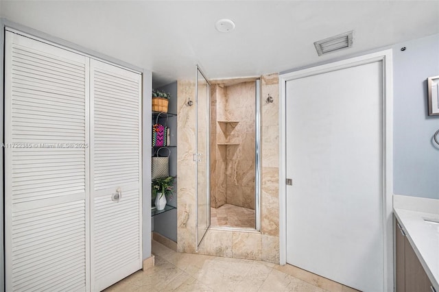 bathroom with vanity and a shower with door