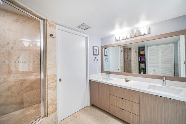 bathroom with vanity and a shower with shower door