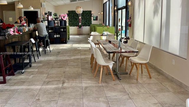 dining area with tile patterned flooring, visible vents, and baseboards