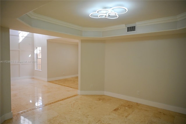 empty room featuring crown molding