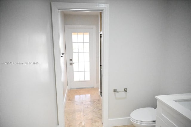 bathroom featuring tile patterned floors, vanity, and toilet