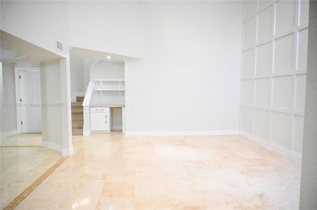 unfurnished room featuring a high ceiling