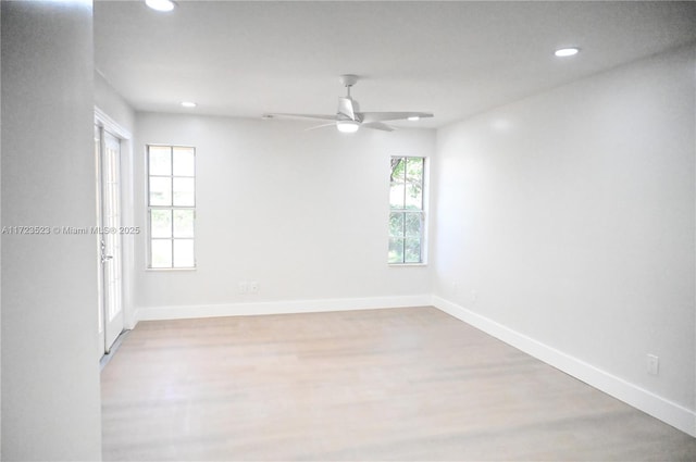 empty room with light hardwood / wood-style flooring and ceiling fan