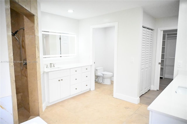 bathroom featuring vanity, toilet, and walk in shower