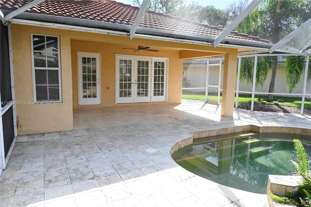 view of pool featuring french doors, a patio, glass enclosure, and ceiling fan