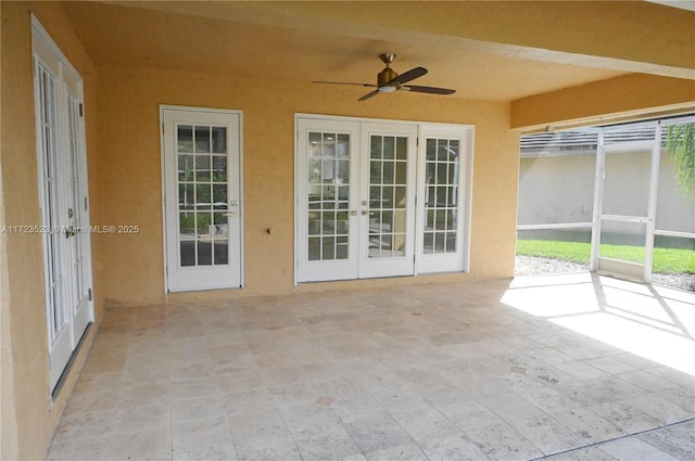 unfurnished sunroom featuring french doors and ceiling fan