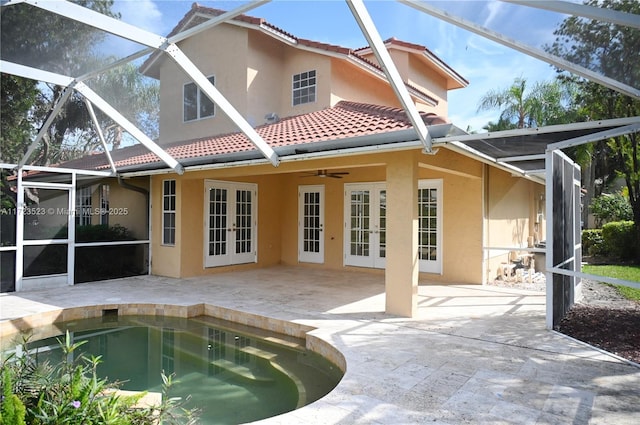 back of property featuring a lanai, a patio area, ceiling fan, and french doors