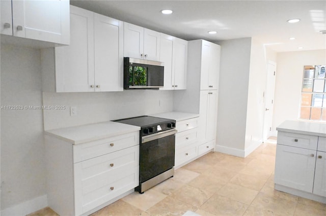 kitchen with white cabinets and appliances with stainless steel finishes