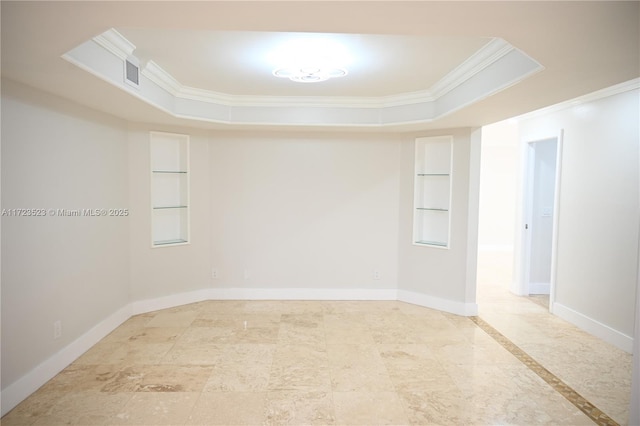 unfurnished room featuring built in features, crown molding, and a tray ceiling