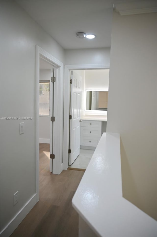 hallway with light hardwood / wood-style flooring