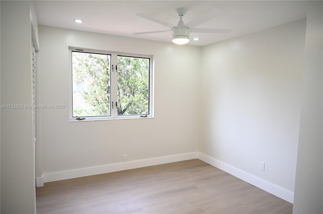 spare room with light hardwood / wood-style floors and ceiling fan