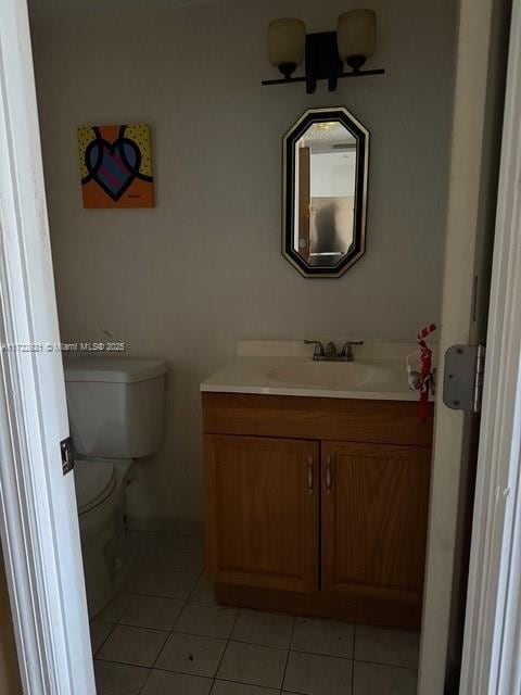 bathroom with tile patterned floors, vanity, and toilet