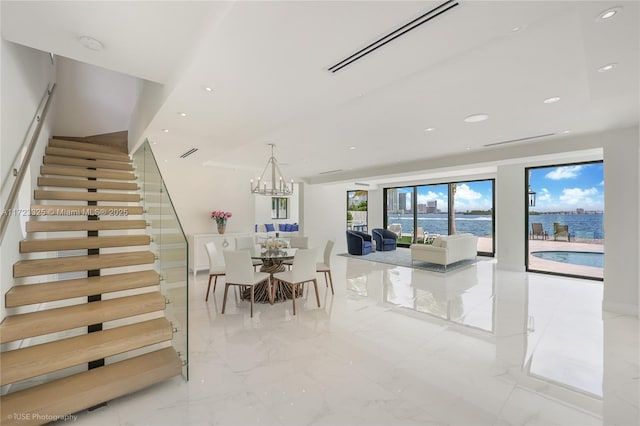 interior space featuring a water view and an inviting chandelier