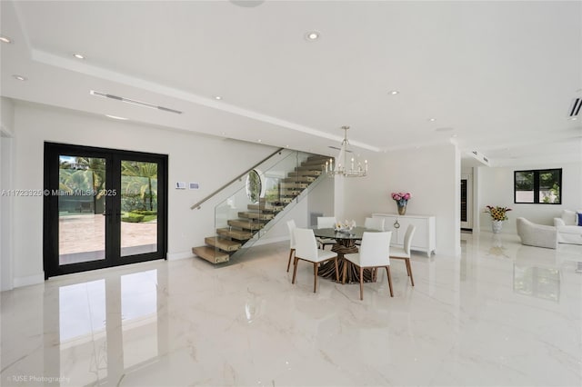 dining room with a notable chandelier, a wealth of natural light, and french doors