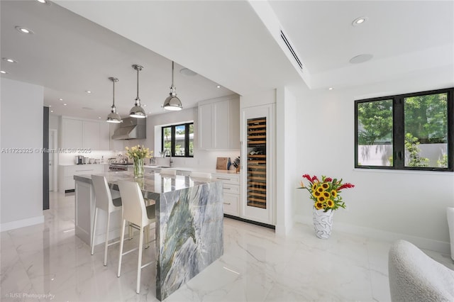 dining space with a raised ceiling and sink