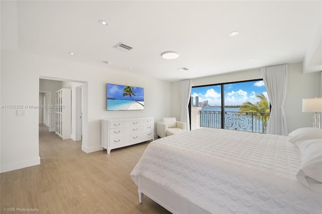 bedroom with access to outside and light hardwood / wood-style flooring