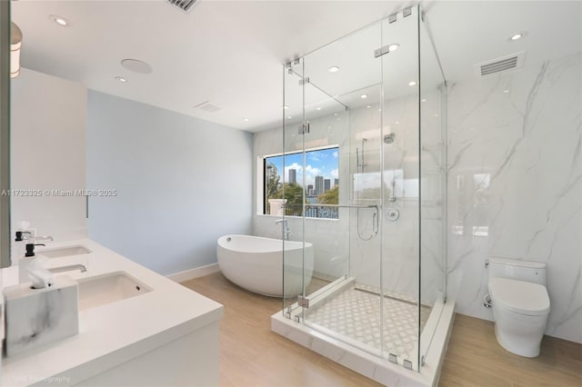 full bathroom featuring hardwood / wood-style flooring, vanity, toilet, and shower with separate bathtub