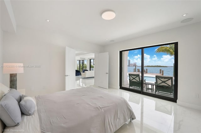 bedroom featuring a water view, access to outside, and multiple windows