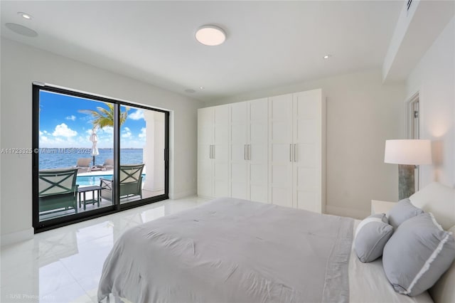 bedroom featuring access to outside and a water view