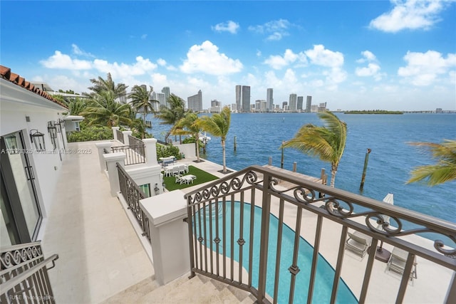 balcony with a patio area and a water view