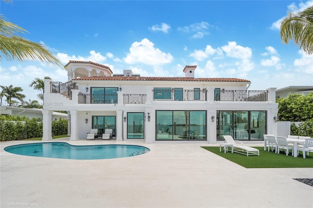 rear view of house with a balcony and a patio area