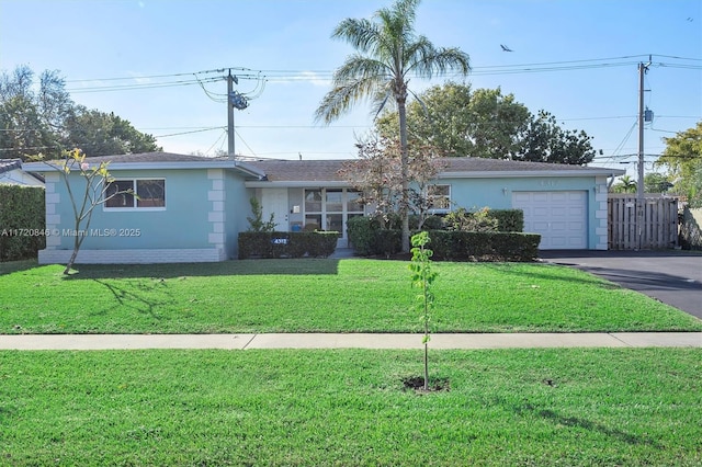 ranch-style home with a garage and a front lawn