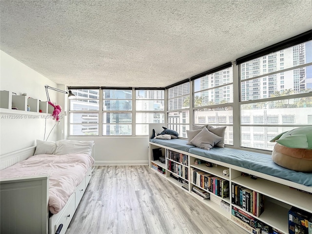 interior space featuring light hardwood / wood-style flooring and a textured ceiling