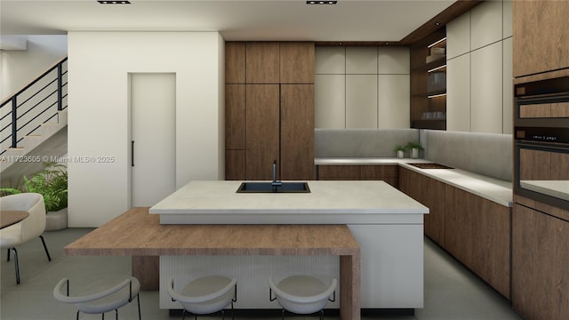 kitchen featuring a breakfast bar, a kitchen island, black double oven, and sink