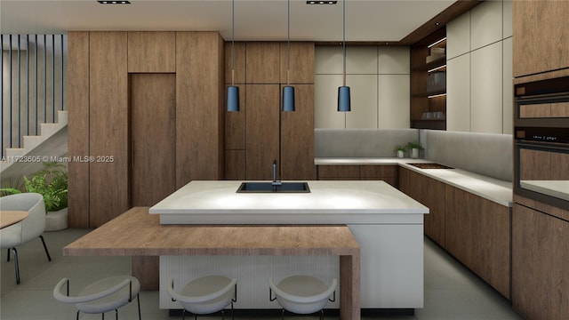 kitchen with a kitchen breakfast bar, a kitchen island, pendant lighting, and sink