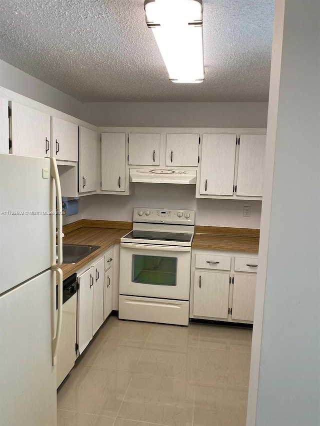 kitchen featuring a textured ceiling, white appliances, and white cabinetry