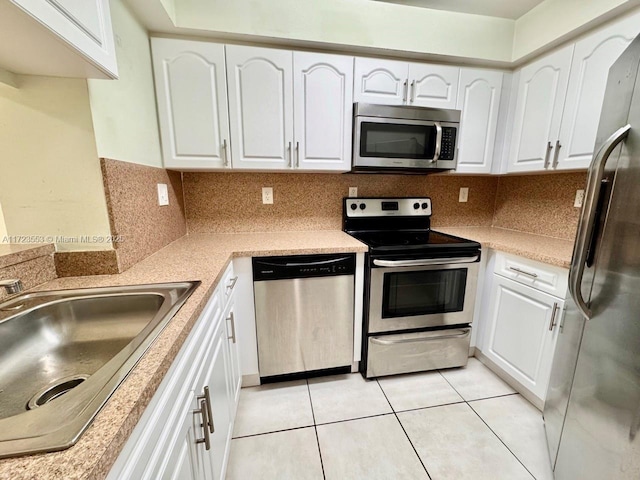 kitchen featuring white cabinetry, light tile patterned flooring, and stainless steel appliances