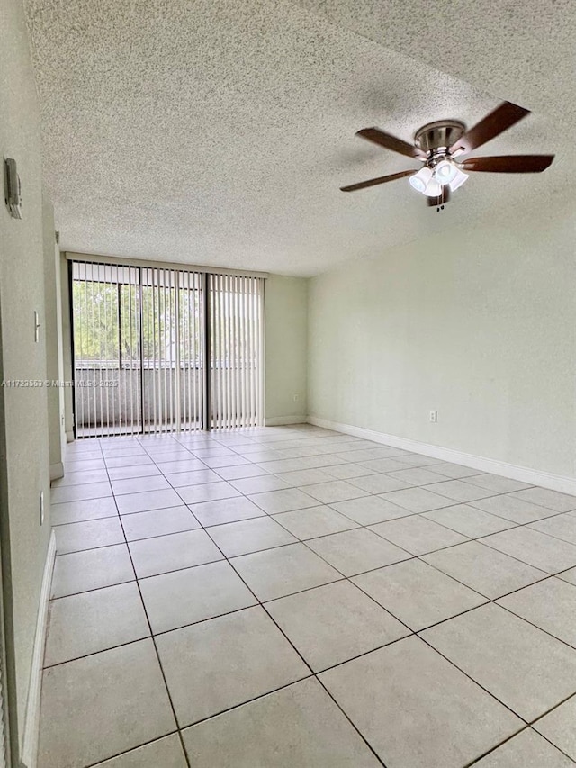 tiled empty room with ceiling fan