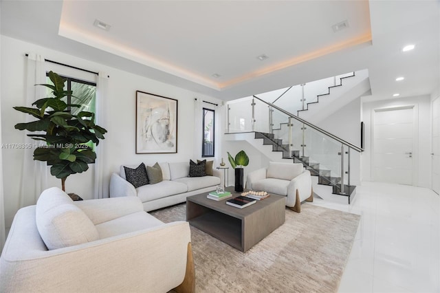 tiled living room featuring a tray ceiling